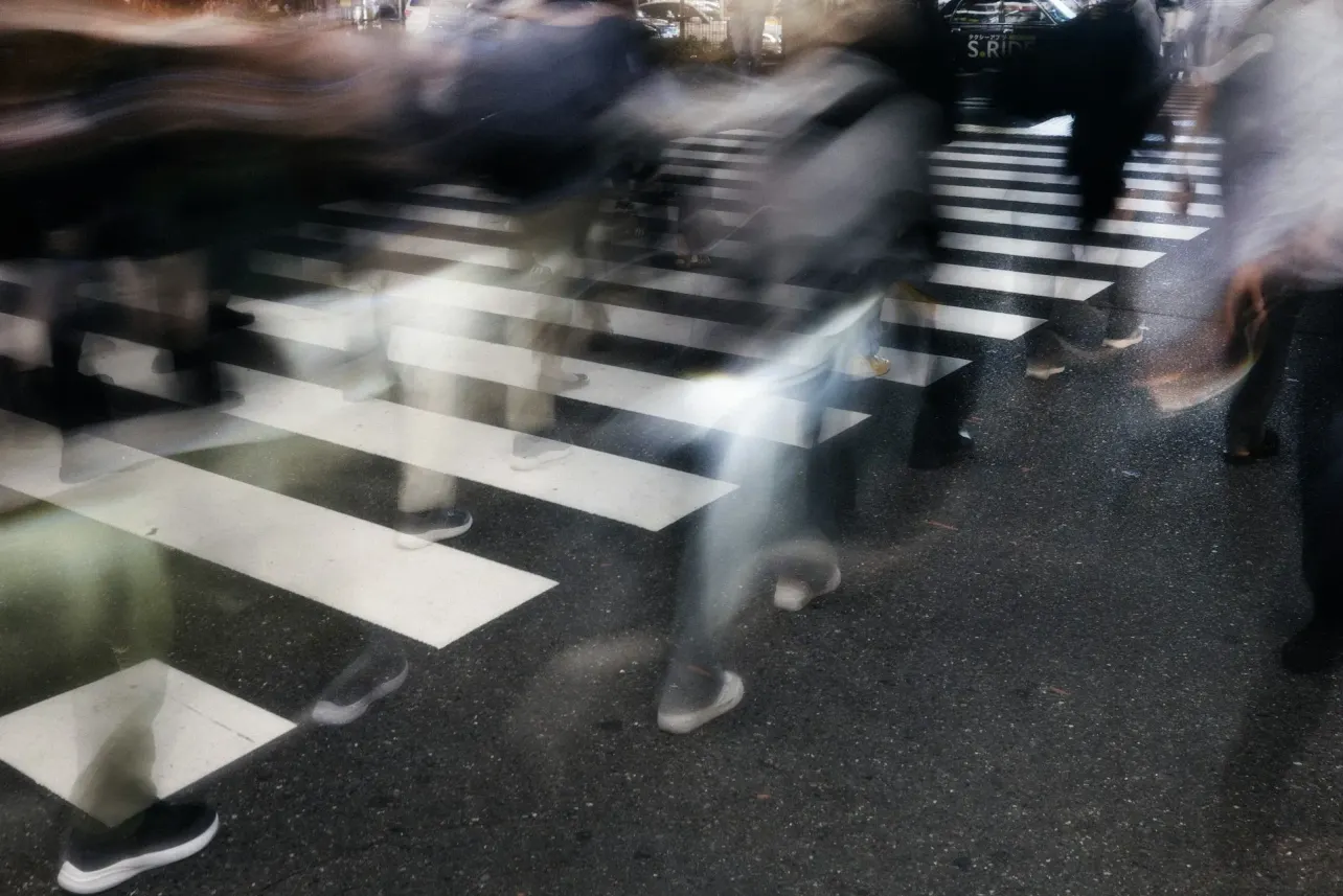 Long exposure of commuters on a zebra crossing, symbolising global talent flow across APAC, Europe and the USA in 2025 employer branding.