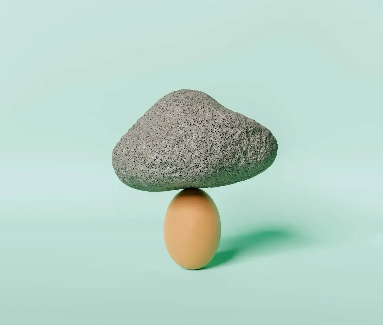 A large stone balanced on an egg, representing the tension between employer brand promise and the internal truth required to support it.