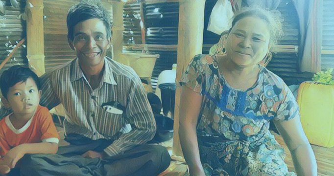 Image of Watsi's patient Hla at her home sitting with her husband and kid