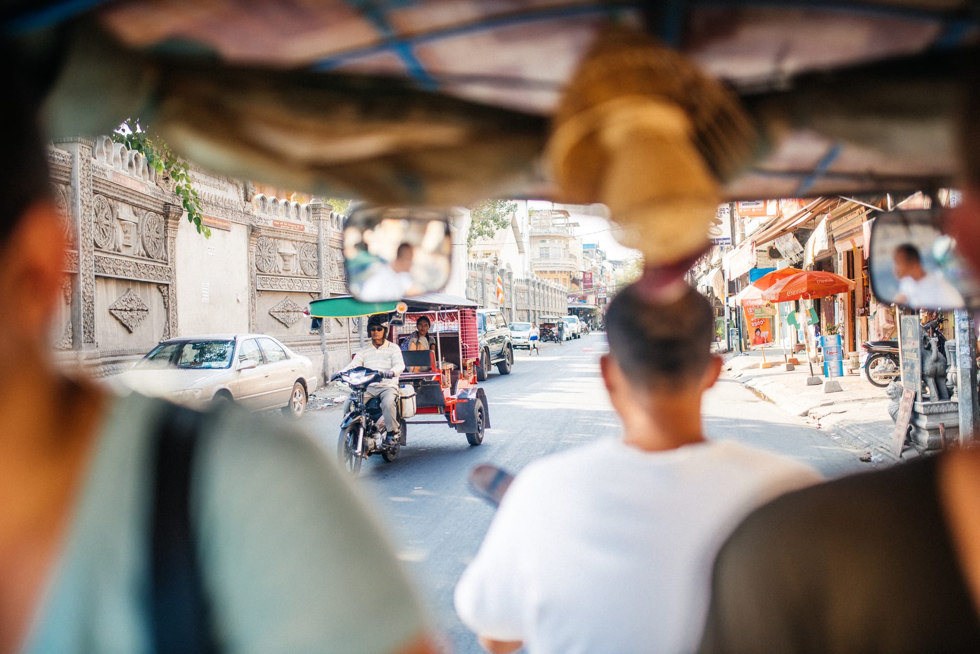 A photo of a tuk-tuk driver on the streets of Phnom Penh, Cambodia