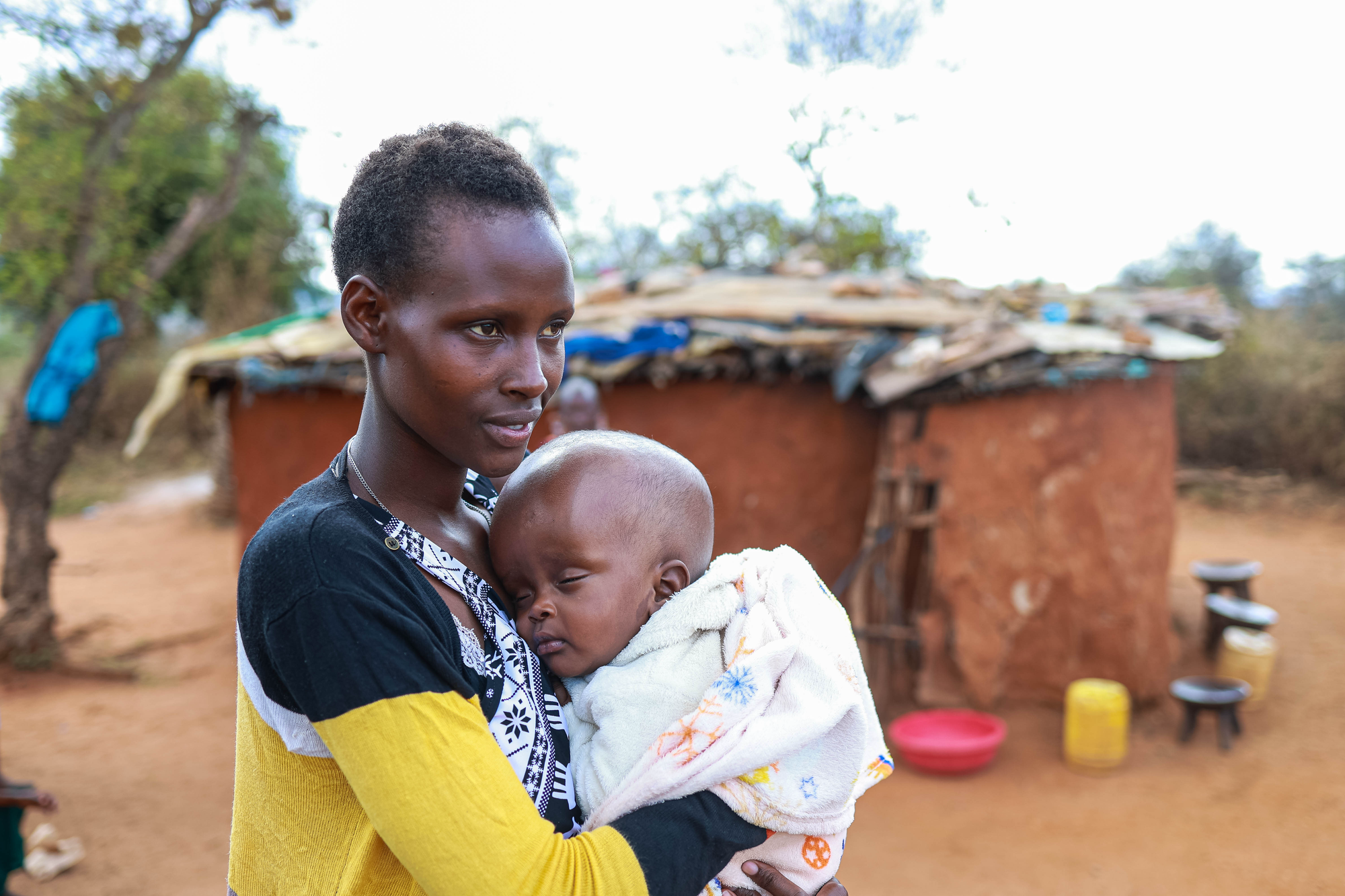 A photo of Little Ryan at home with his mother after surgery supported by Ryans from around the world.