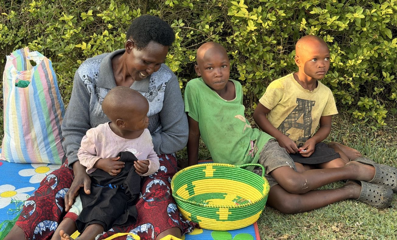 Louis with his grandmother and older sisters at their home.