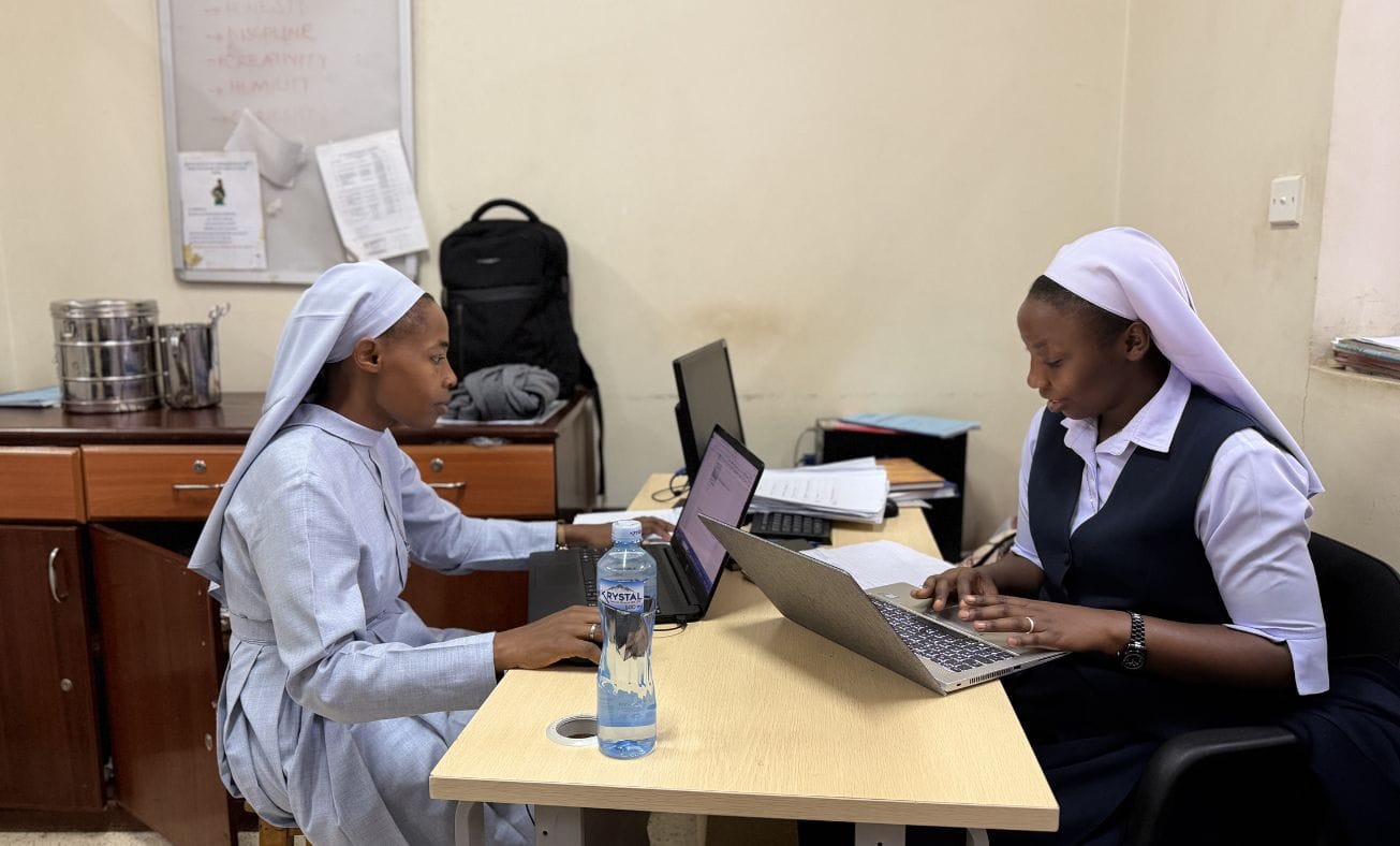 Sister Juliet and Sister Charity documenting each patient’s story.