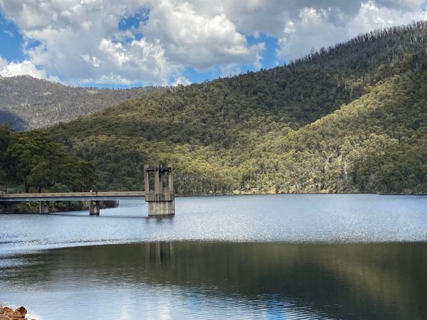 The water inflow at Corin Dam, with the sloping hills in the background.