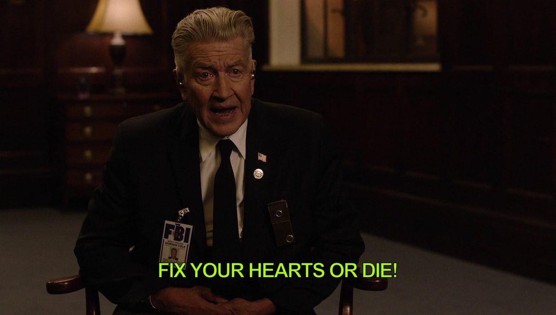 David Lynch, sitting in a chair with the words "fix your hearts or die!"