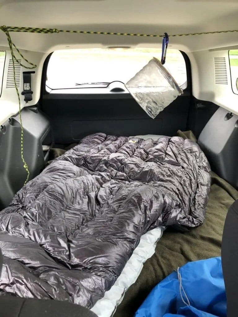 A makeshift camper setup in the back of my Jeep Patriot.
