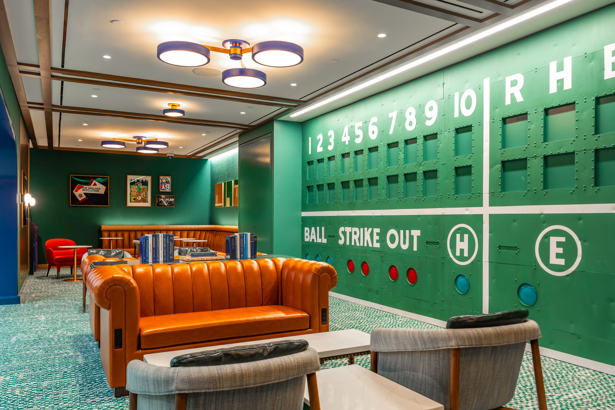 The Dugout at the Boston BlueHouse with a green baseball scoreboard on the wall.