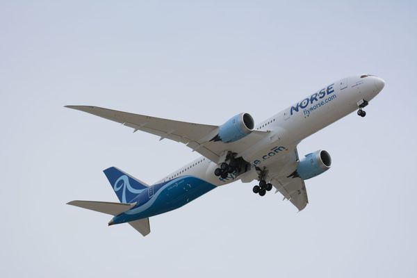 A Norse Atlantic Boeing 787 Dreamliner in the sky with its landing gear extended.
