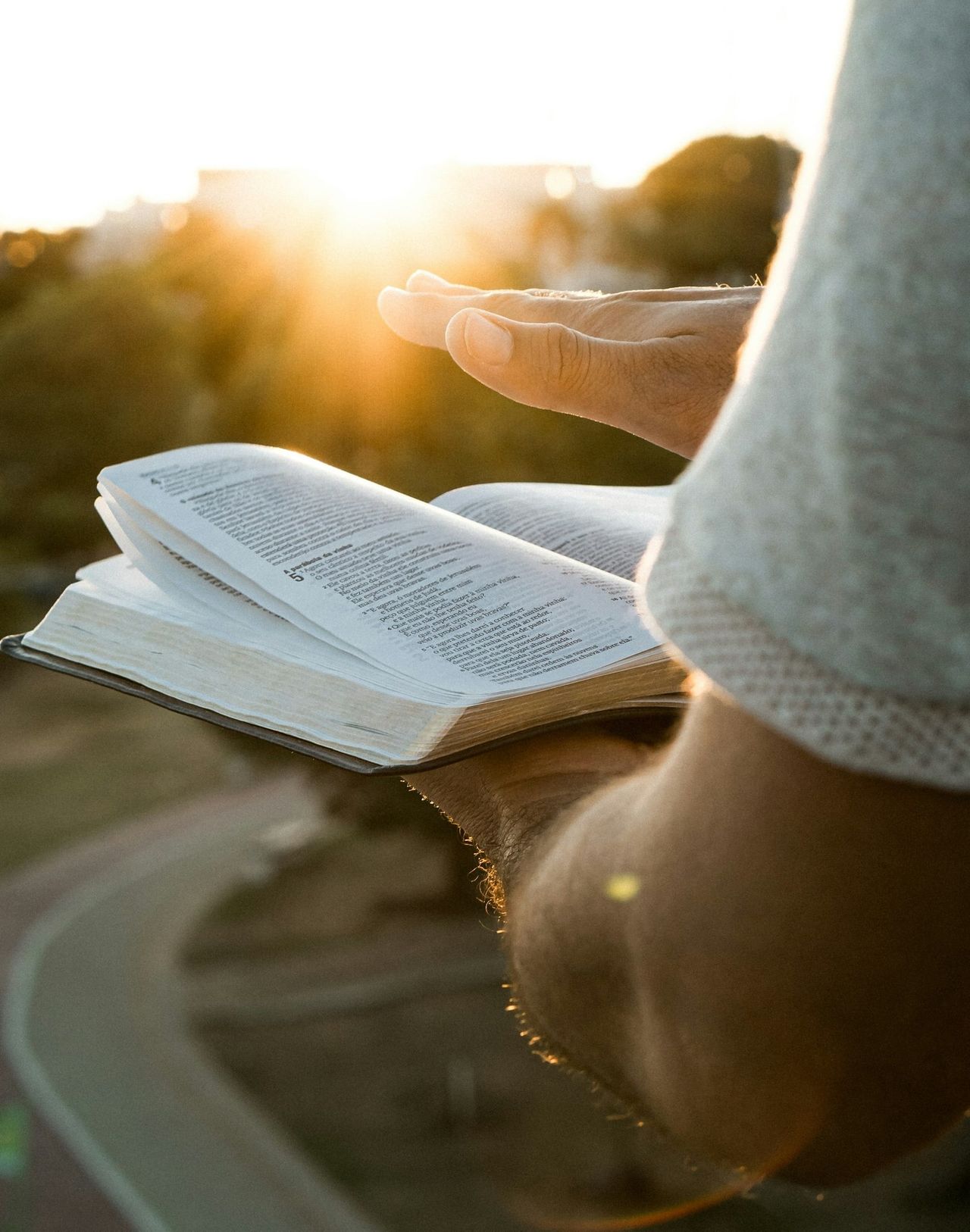 A person reading the Bible in quiet morning light, symbolizing sanctification, holiness, spiritual growth, and becoming more like Christ.