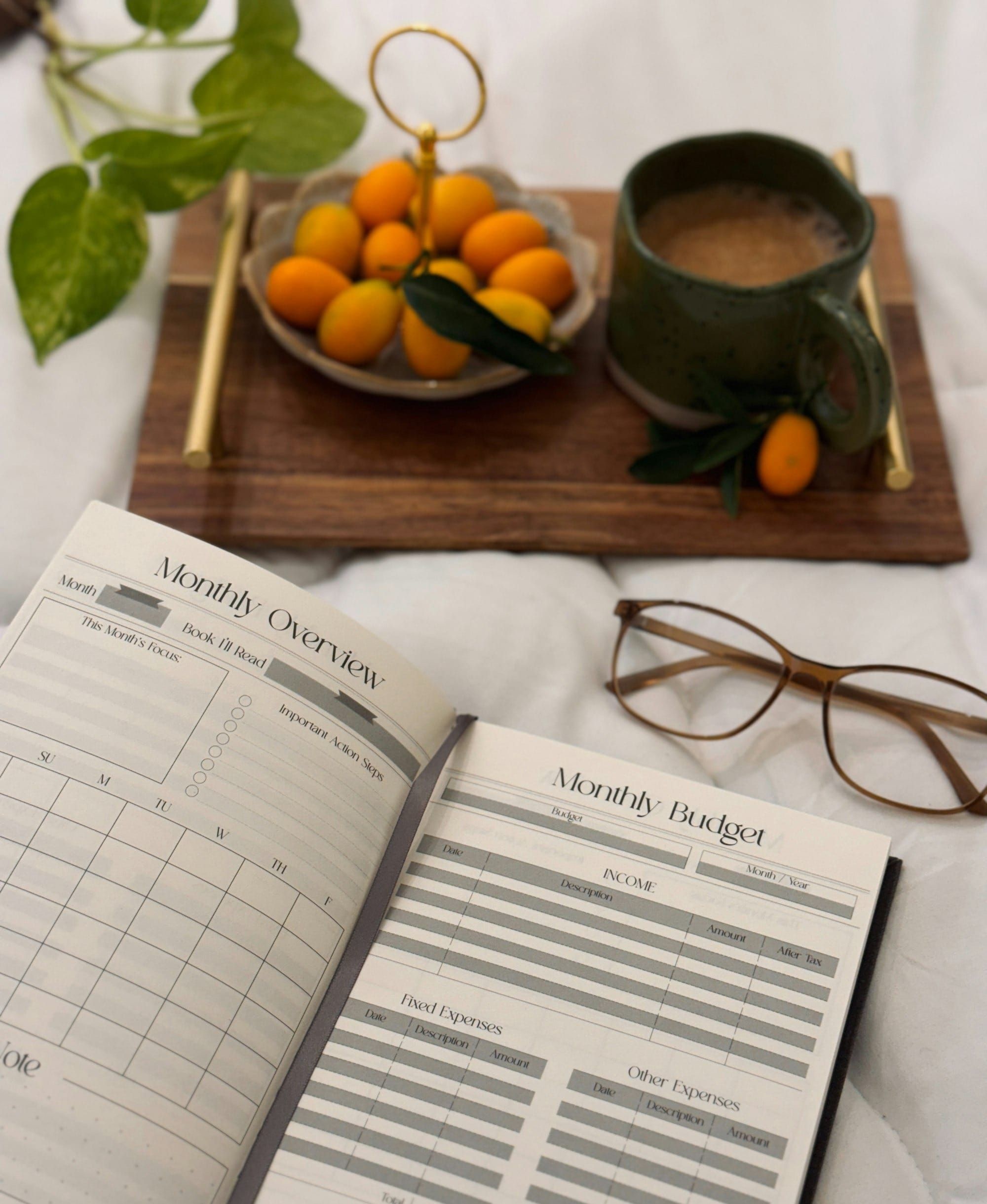 A budget notebook, pen, and coffee, representing Christian budgeting and biblical stewardship. 