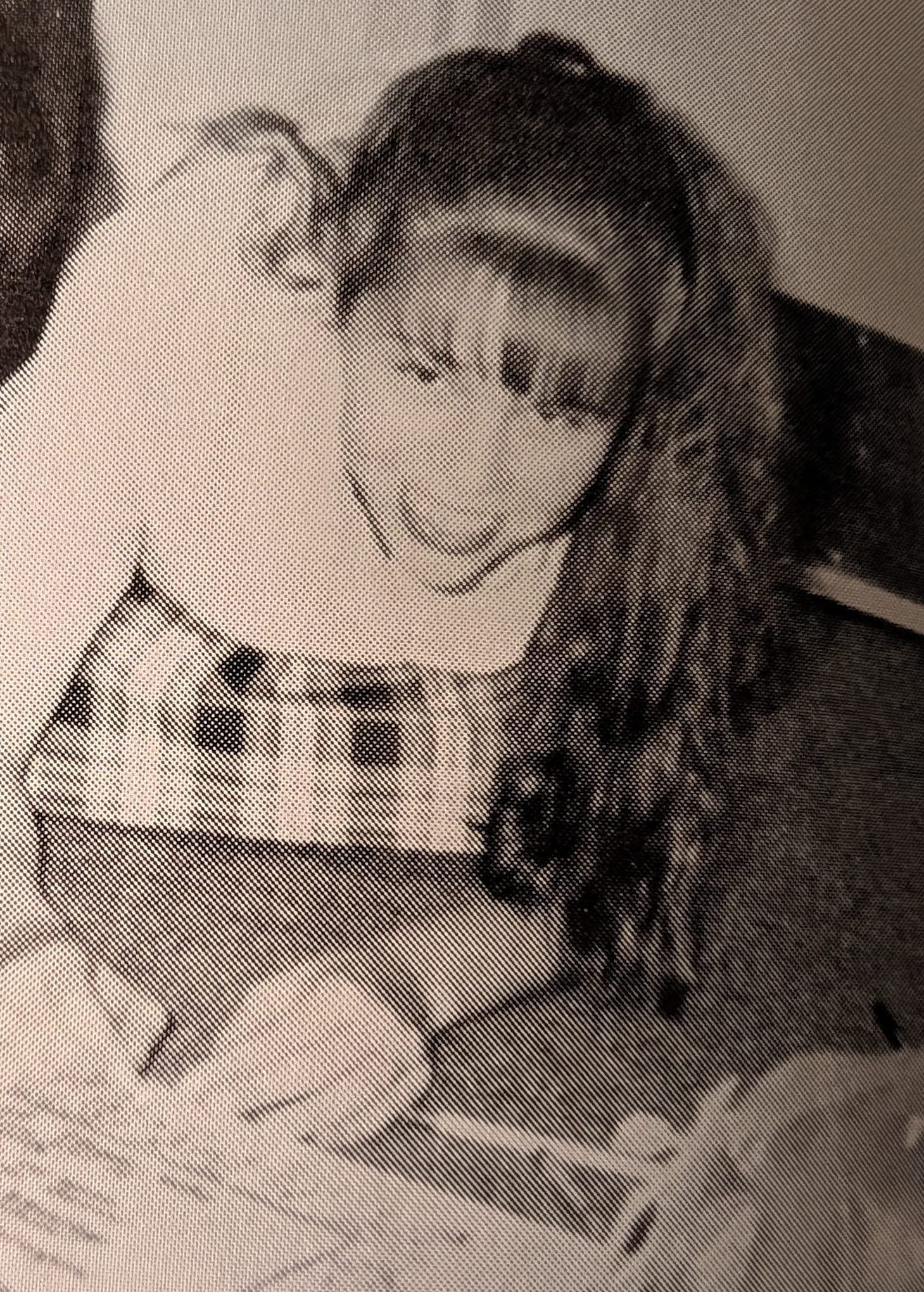 This is a black-and-white image of me in grade school, crouched down to work on an art piece.