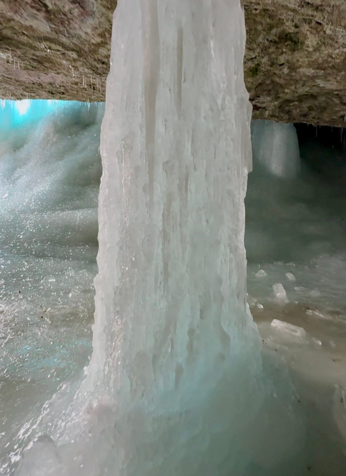 Massive icicle extending from the top to bottom with a diameter of ~2 feet.