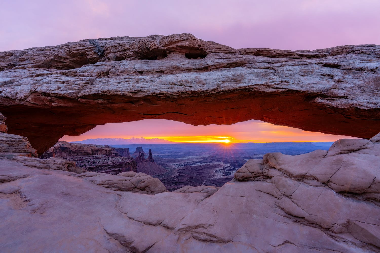 Sunburst through Mesa Arch at sunrise in Canyonlands National Park