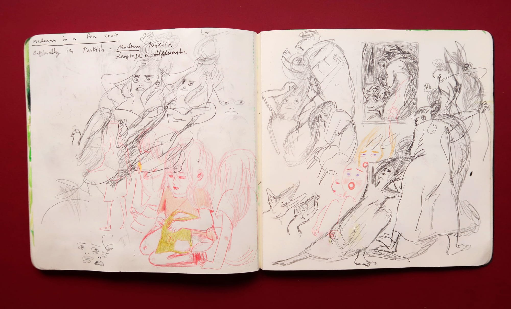 Double spread sketchbook spread with repeated pencil character sketches.