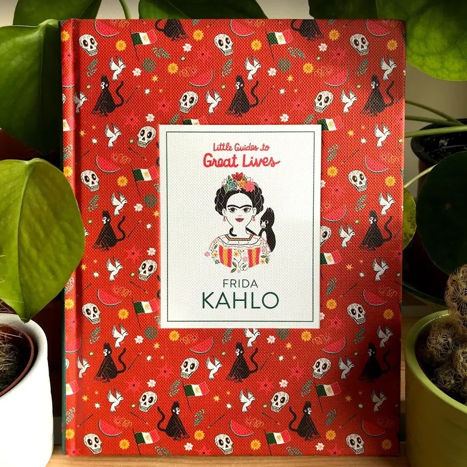 Red book with pattern displaying watermelons, skulls, sparkles and the Mexican flag, with an illustration of Frida Kahlo in the middle.