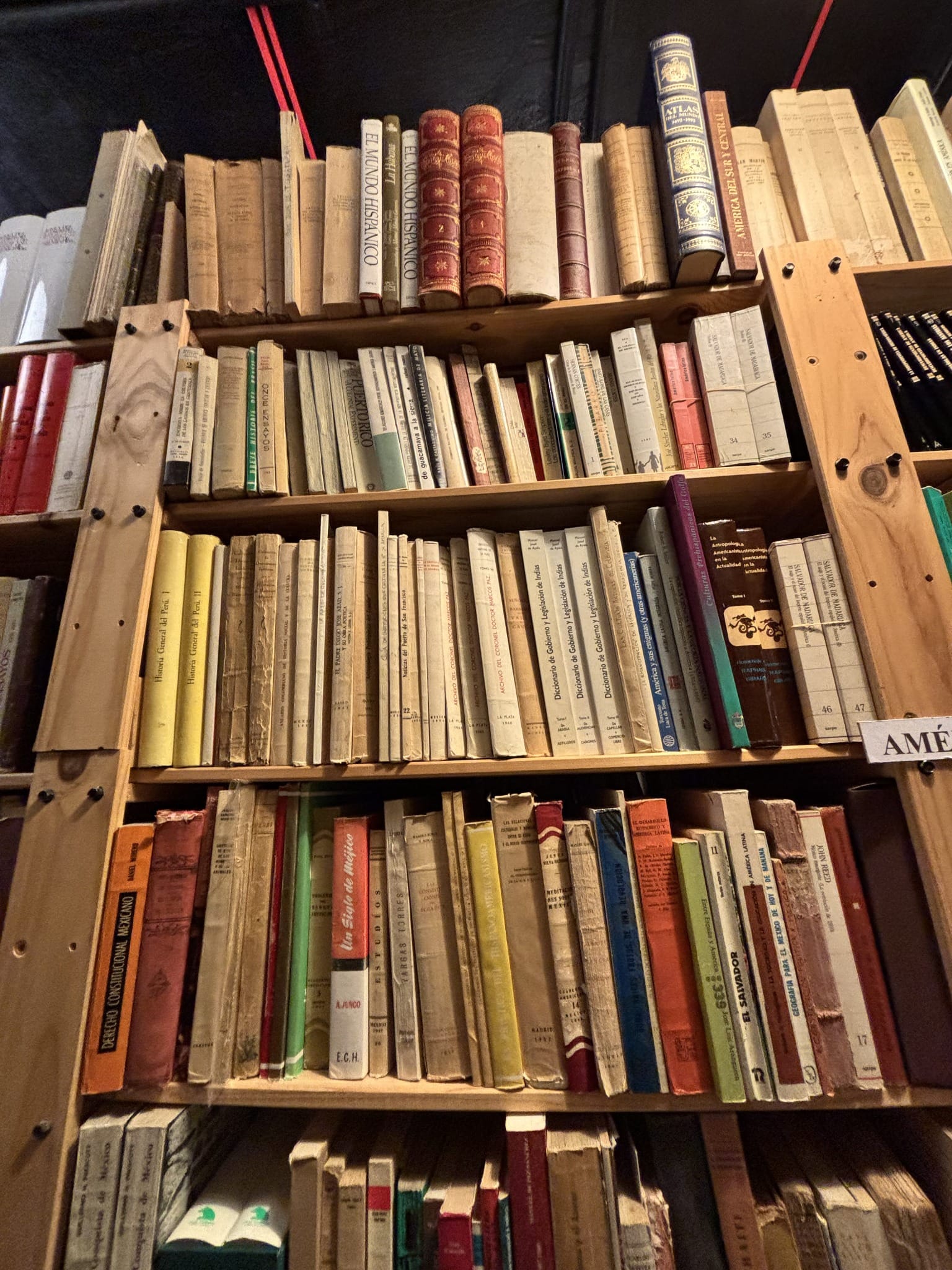 Tall wooden shelves with books on Spanish and Latin American history.
