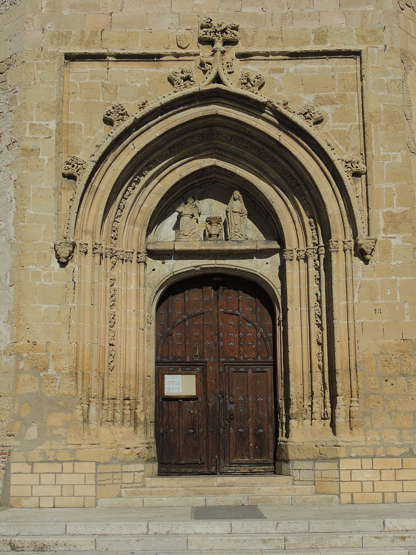 The brick tower and exterior of Santa María church in Aguilafuente.