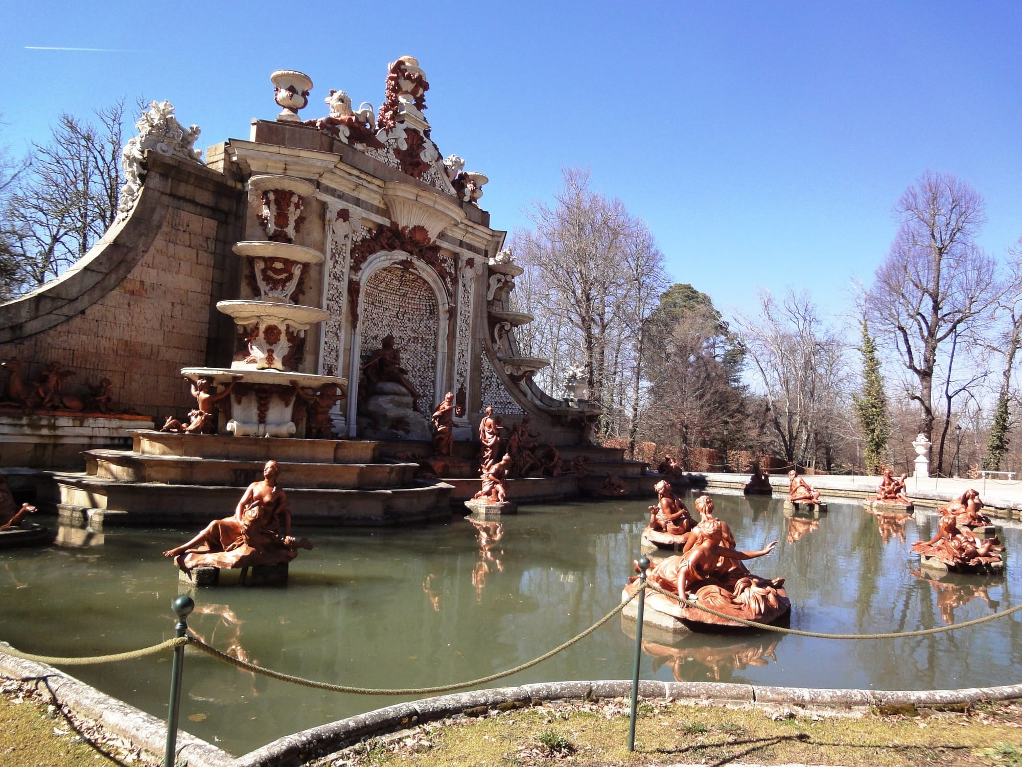 Sculptures and a broad still basin at the Fuente de los Baños de Diana in La Granja.