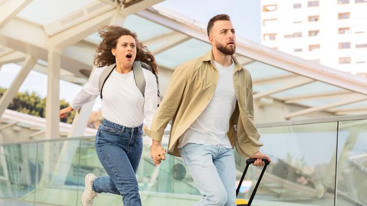 Man and woman running for a plane flight they are late for
