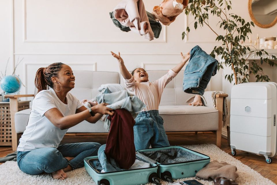 Mother and daughter packing for vacation.