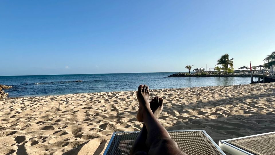 Man on beach chair on a sandy beach in Antigua and Barbuda
