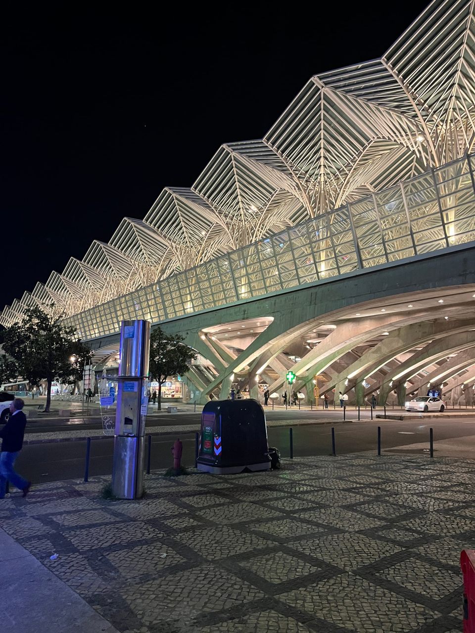 Train station and street sidewalk at night