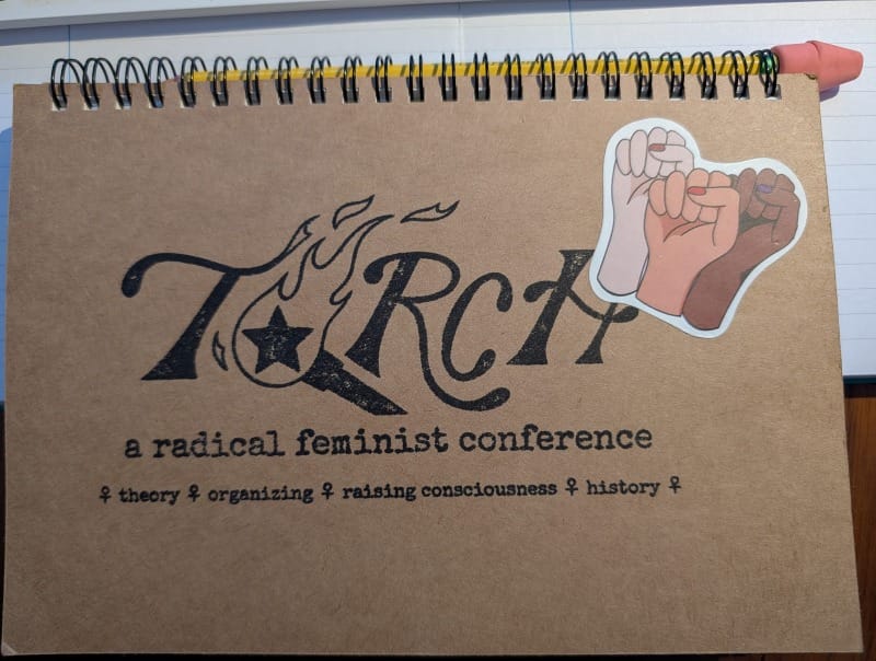 TORCH radical feminist conference notebook with a solidarity fist sticker and Ticonderoga #2.