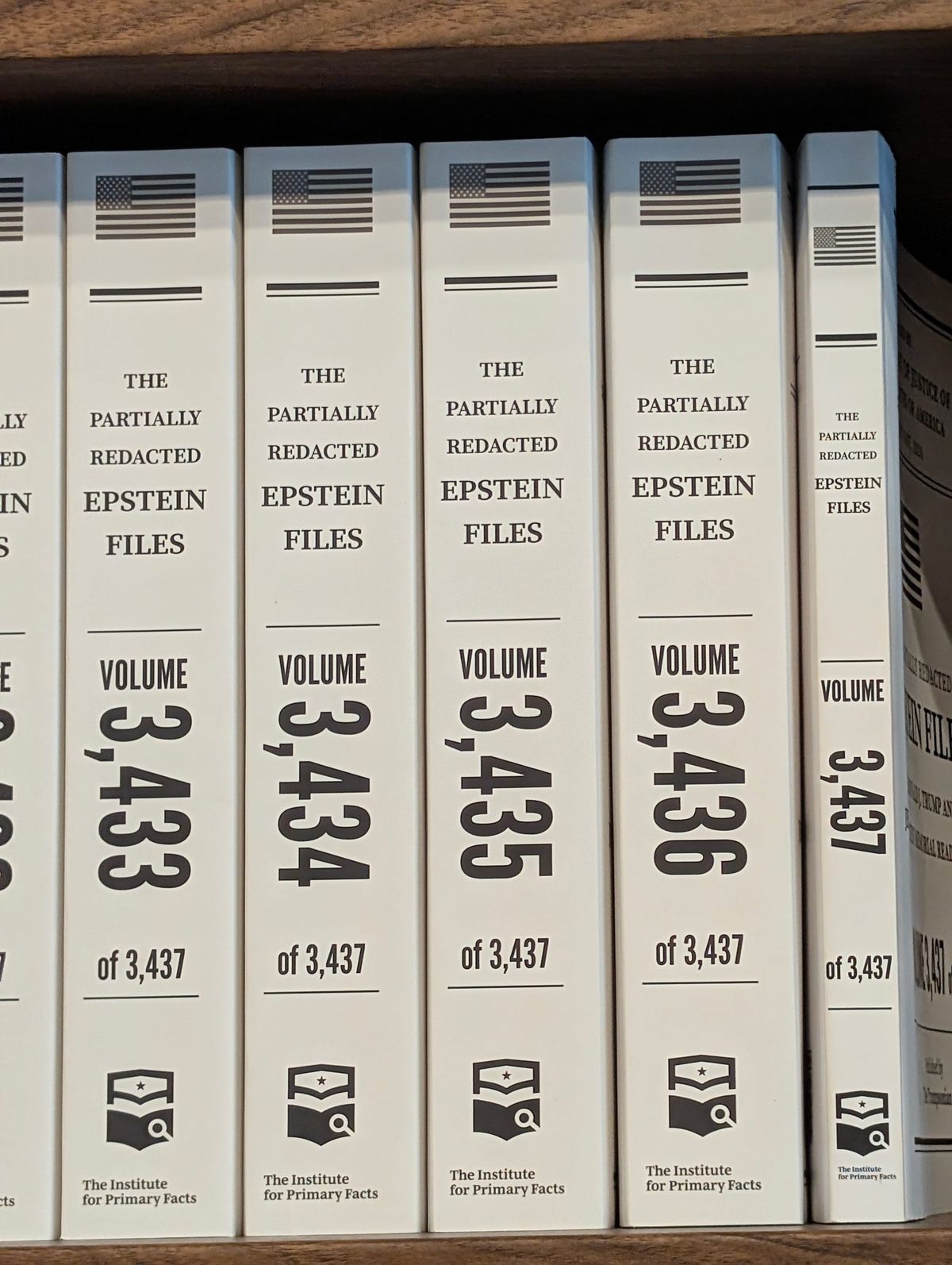 Spines of the last 5 volumes of the Partially Redacted Trump-Epstein Files as printed and displayed in Washington DC.