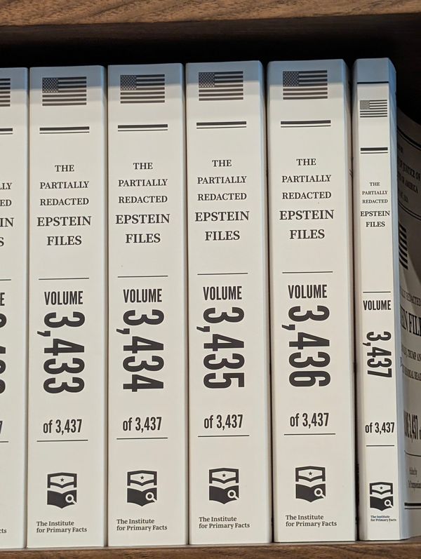 Spines of the last 5 volumes of the Partially Redacted Trump-Epstein Files as printed and displayed in Washington DC.