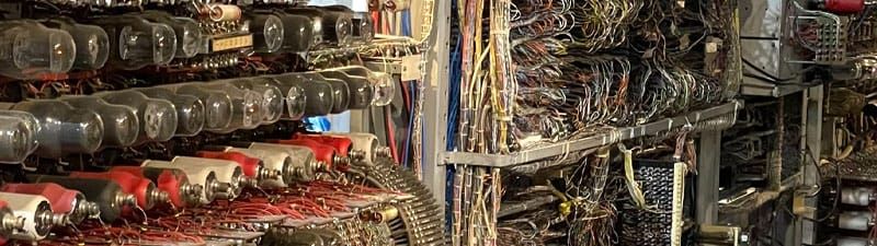 A mass of wires and vacuum tubes in a metal frame. This is the world's oldest and first digital computer.