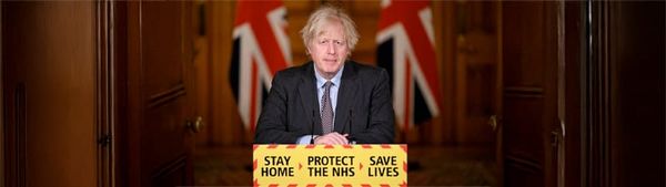 Boris Johnson stands at a podium looking like an absolute wanker.