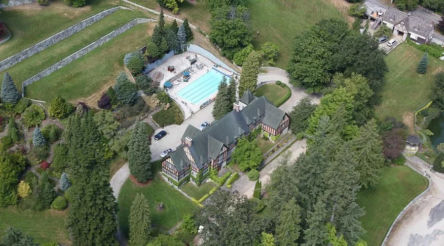 Aerial view of Blaylock Mansion with gardens and pool.