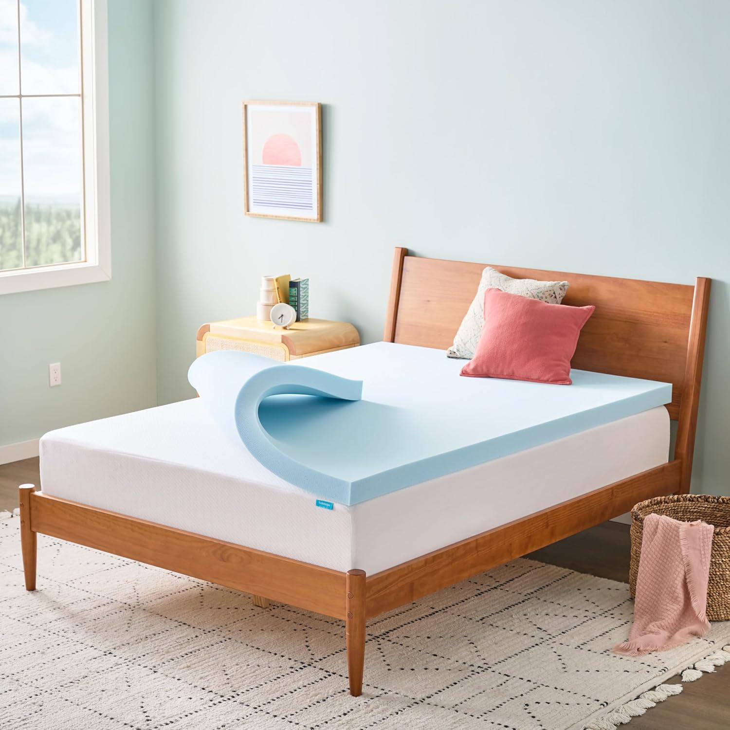Linenspa 3-inch light-blue gel memory foam mattress topper partly rolled back on a queen bed