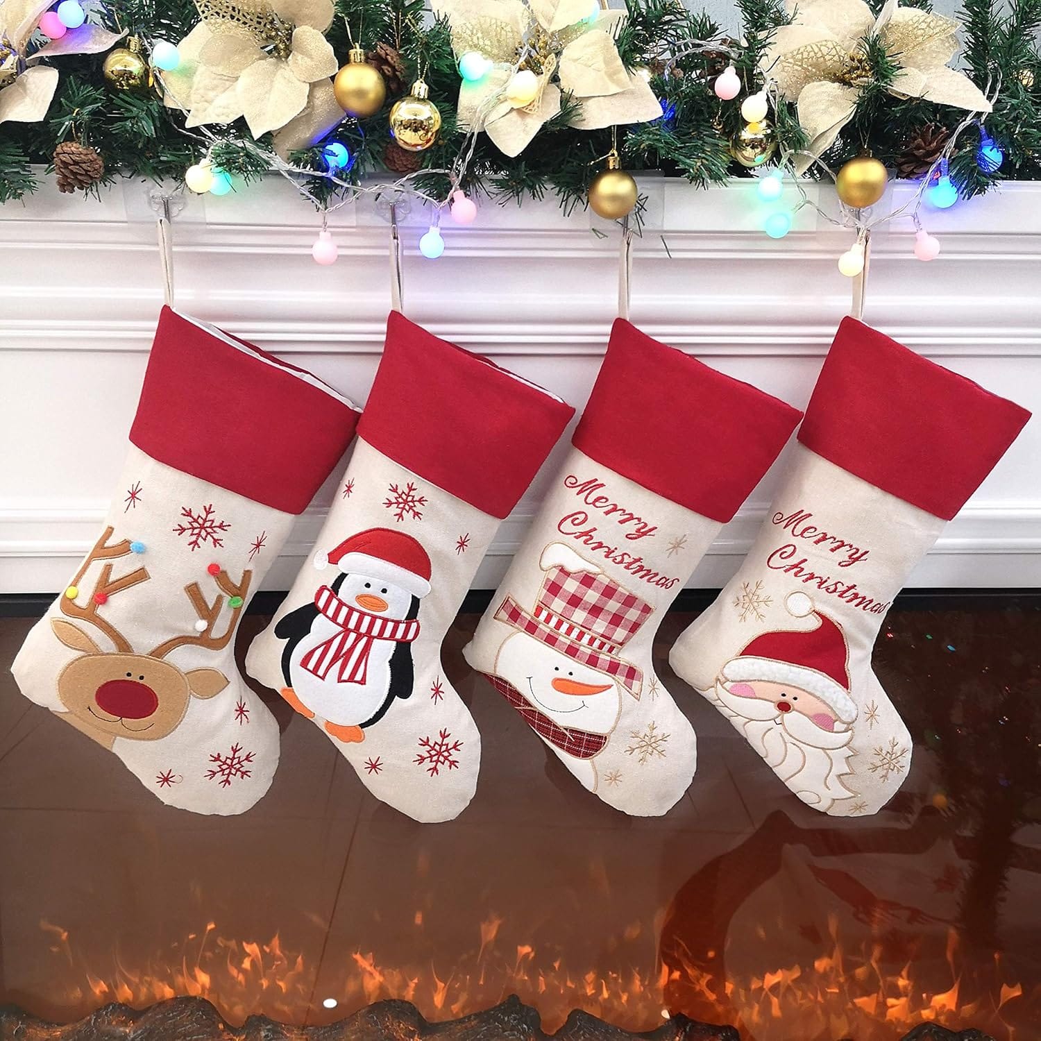 Four red and white Bstaofy felt Christmas stockings with Santa, snowman, reindeer and penguin designs on a mantel