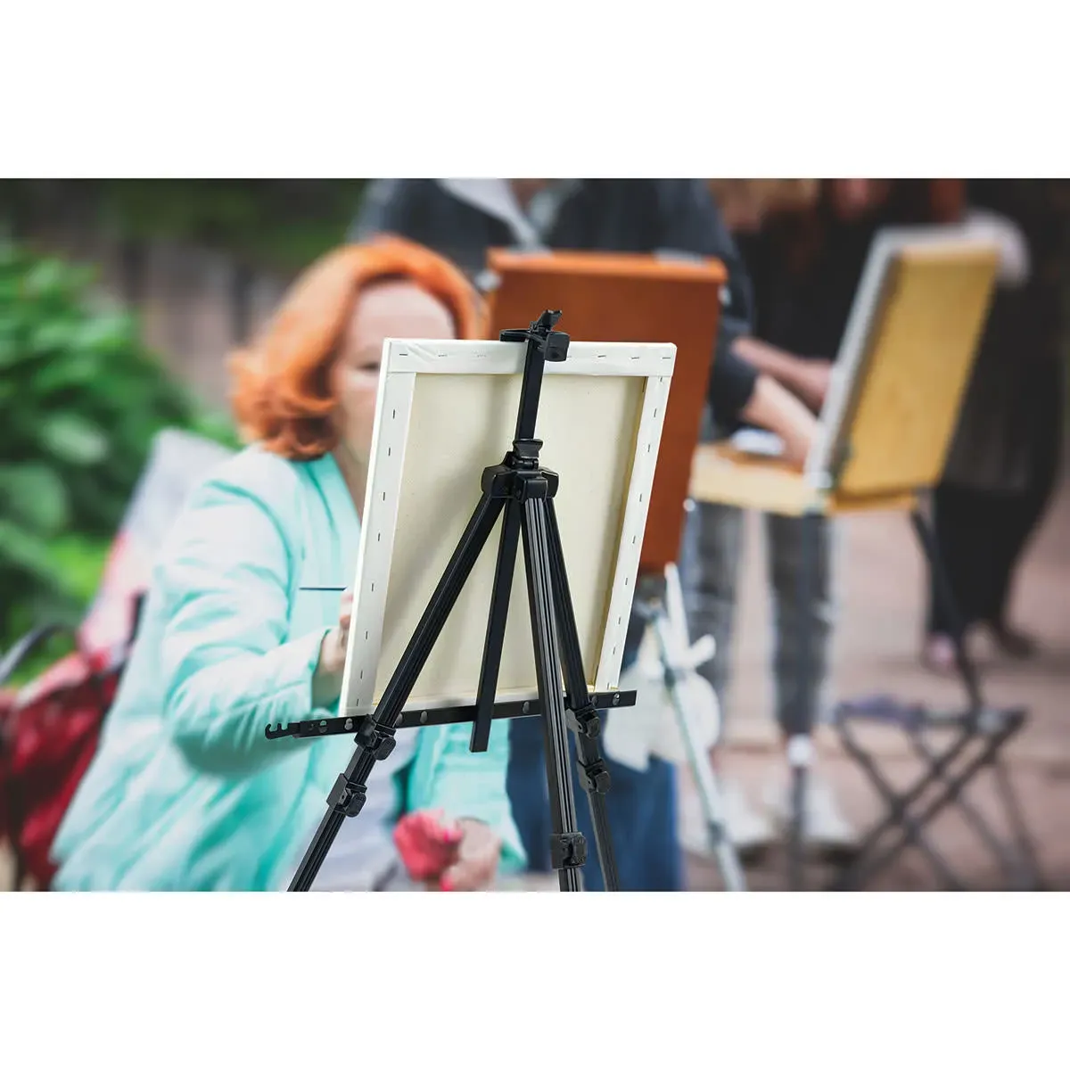 Adjustable easel set at ideal height to support painter's posture and technique