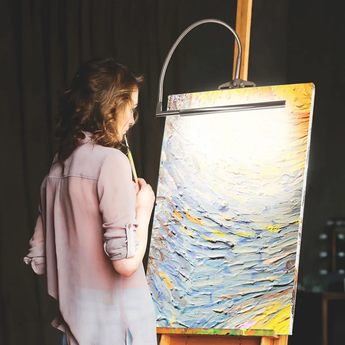 Enhanced easel setup with lighting, palette shelf, and storage solutions