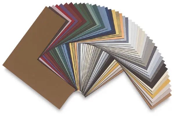 A collection of Crescent decorative matboards in various colors and textures, used for framing and enhancing artwork presentation