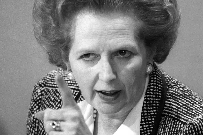 A black-and-white photo of Margaret Thatcher pointing her finger