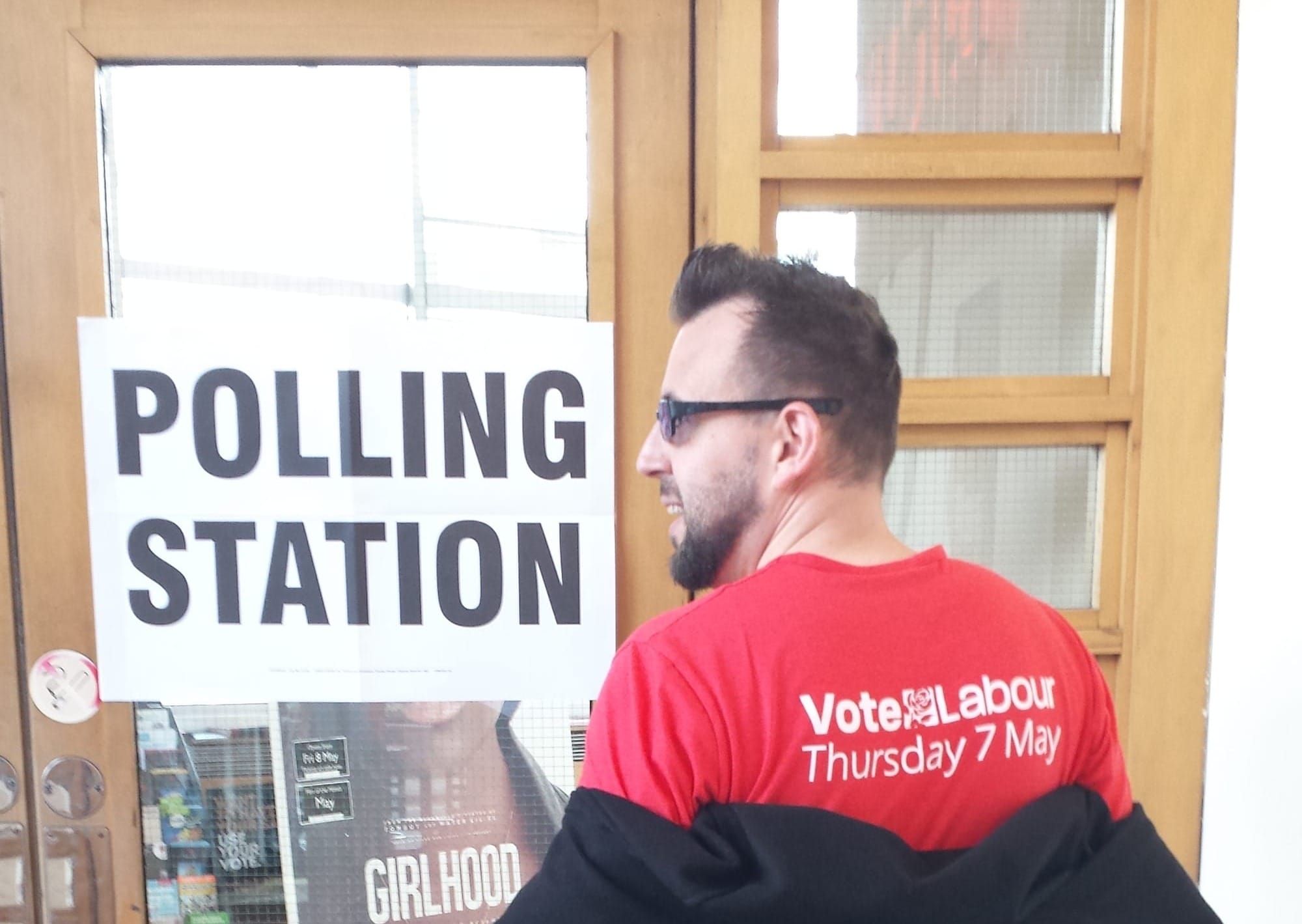 At a polling station, wearing a t-shirt that reads "Vote Labour Thursday 7 May"