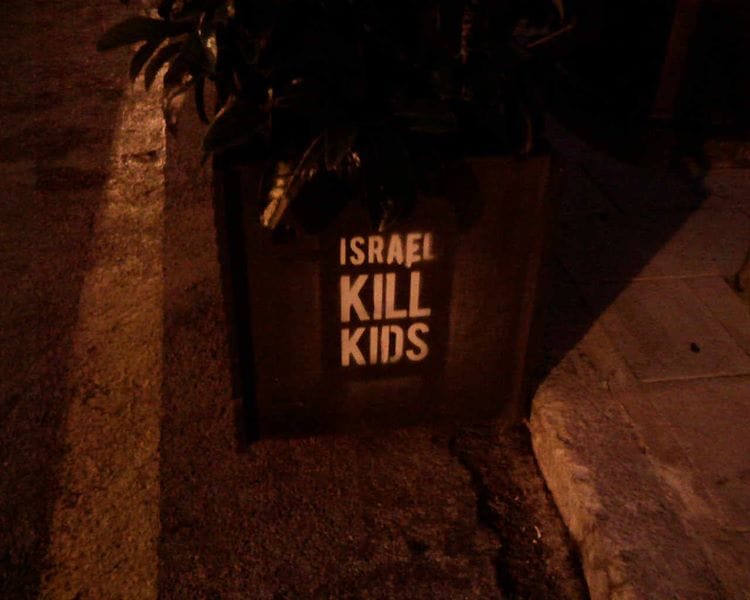 Stencilled graffiti that says "ISRAEL KILL KIDS."