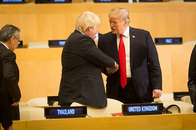 Boris Johnson shaking hands with Donald Trump.