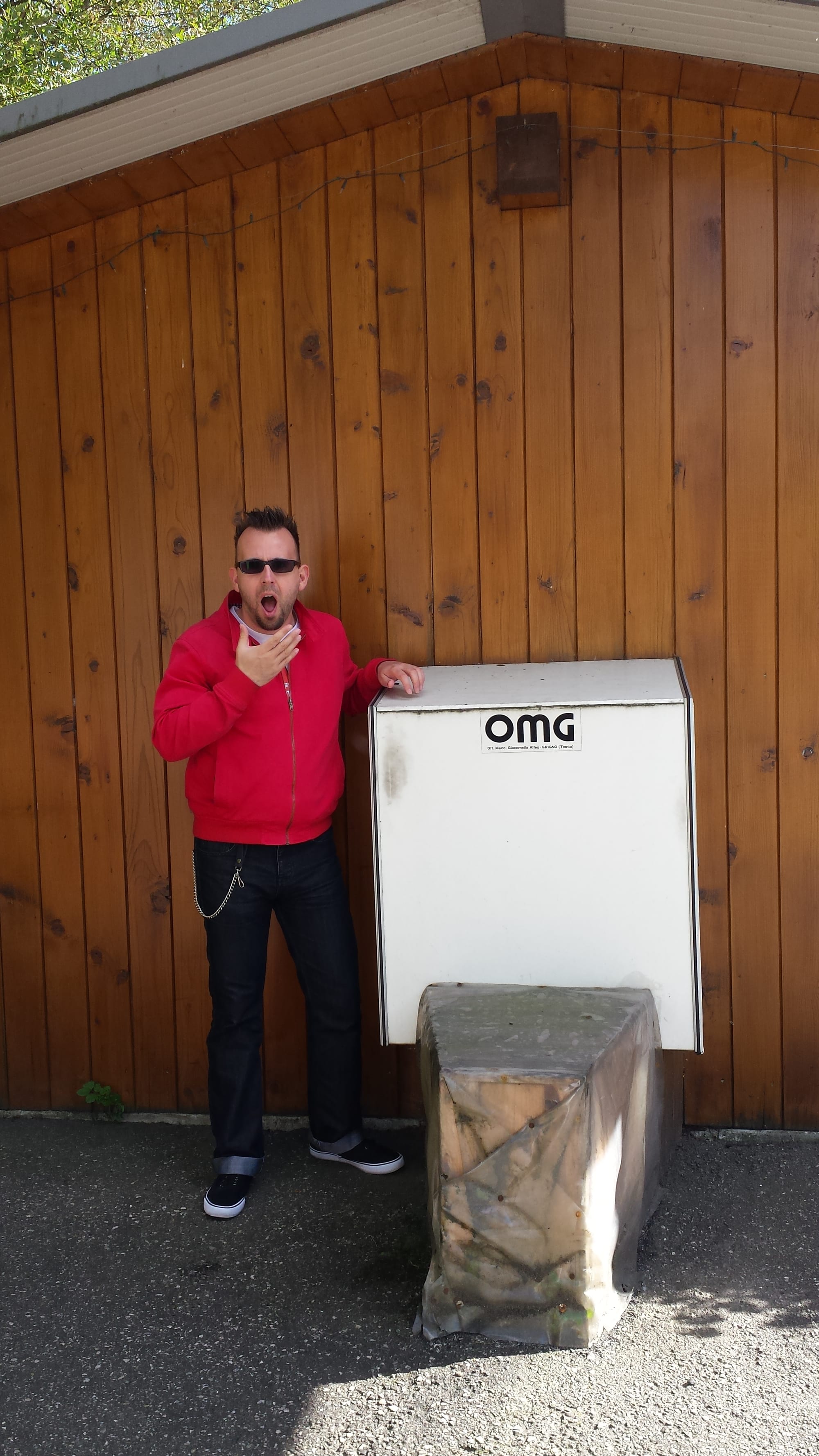 Me, a white person with glasses, dark hair, and stubble, beside a sticker that says "OMG."