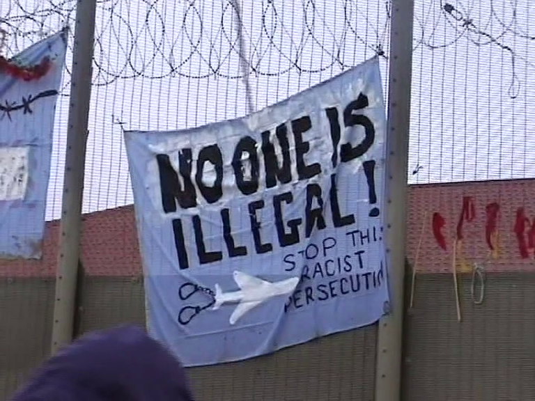 Screenshot from Escape from Doncatraz showing a banner on the walls of Lindholme stating "no one is illegal, stop this racist persecution"