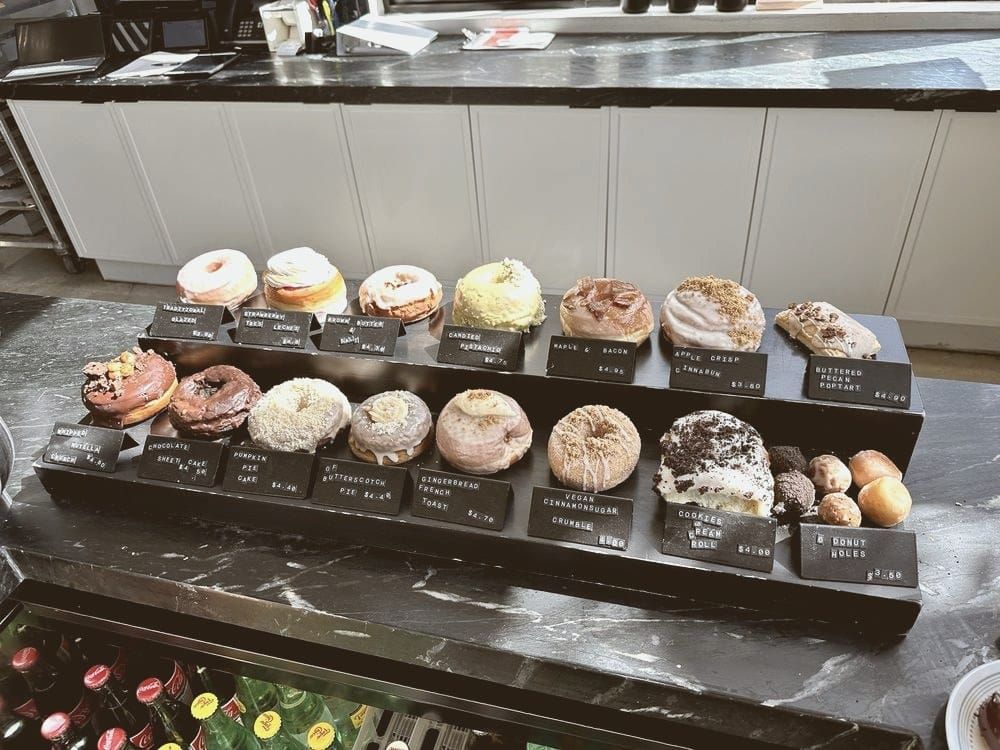 of a glazed donut resting on parchment paper, warm morning light, no people, no text
