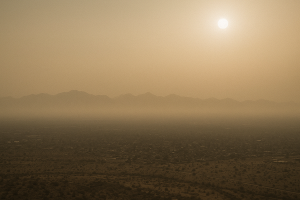 of a hazy Phoenix valley at midday, mountains barely visible through brownish smog, no people