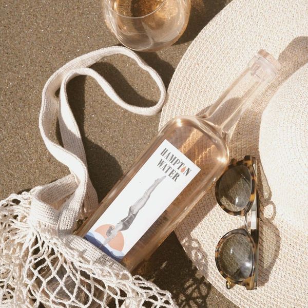 of chilled rosé wine in stemmed glasses on a white linen table, warm desert evening light, no people