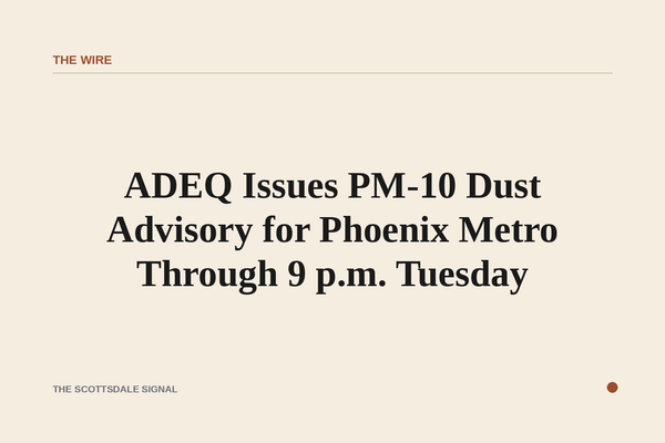 of a hazy desert sky over a flat urban valley, thick brown dust obscuring the horizon at midday