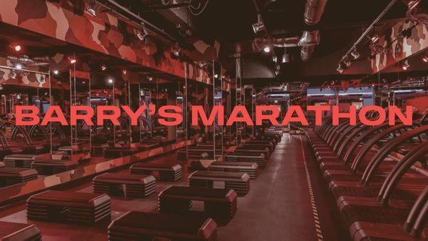 Empty fitness studio interior at dawn, red ambient lighting, treadmills in rows, no people
