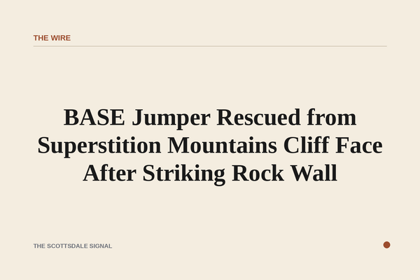 of a rugged desert mountain cliff face at midday, rocky terrain and sparse desert vegetation, no people, no text
