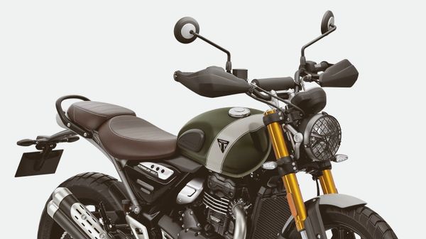 of a motorcycle handlebar and instrument cluster on a desert road at morning light, no people, no logos